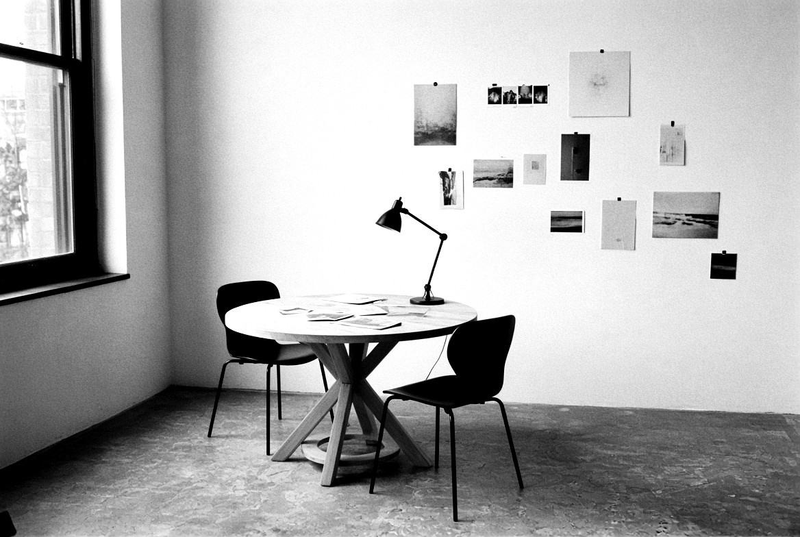 Studio table and pinned photographs